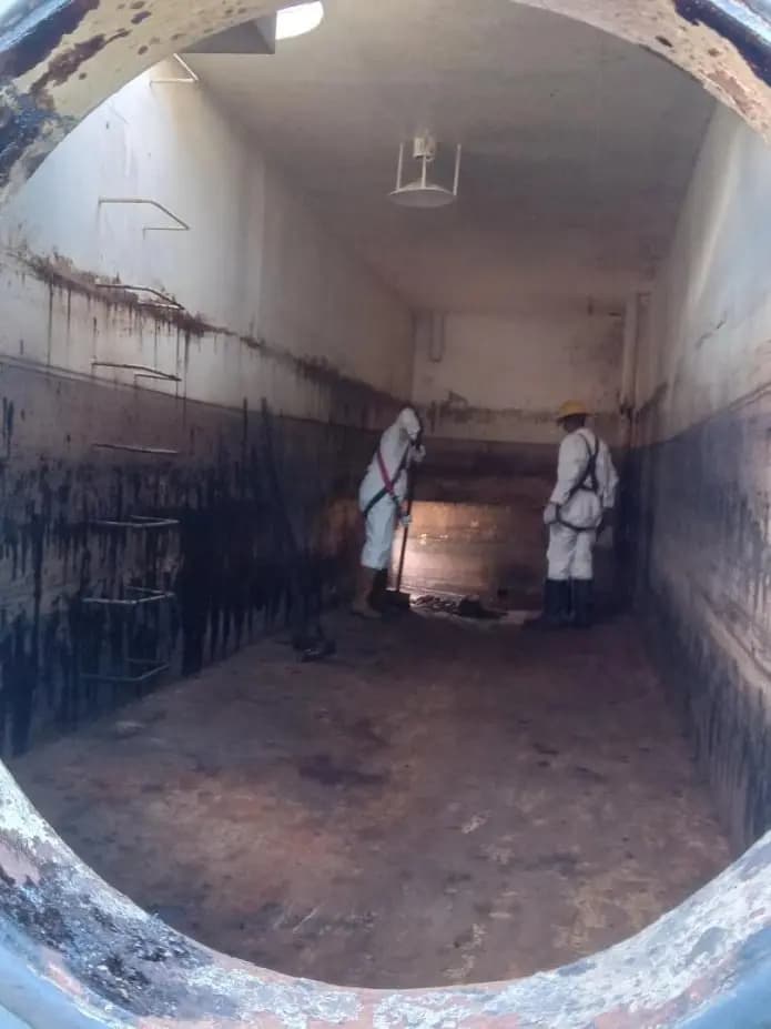 Crew cleaning the interior of a storage tank